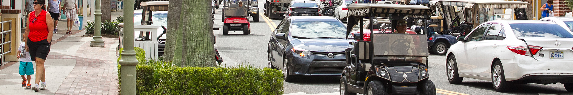 photo of The Villages with golf carts and cars